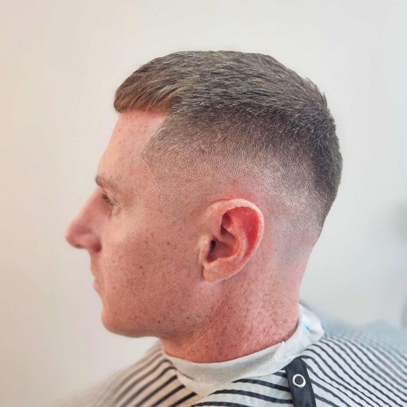 Skin fade with a short textured top