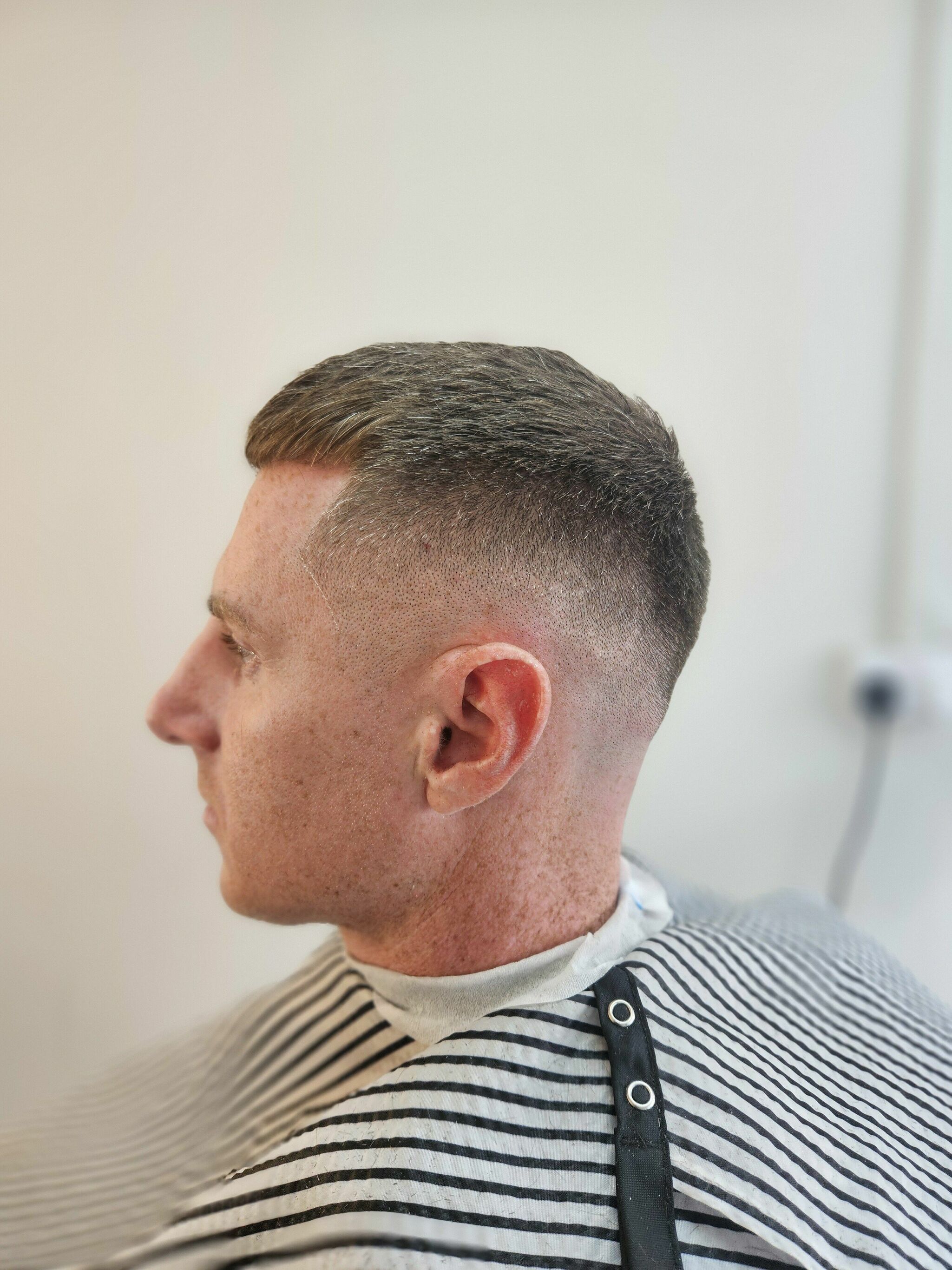 Skin fade with a short top, side view