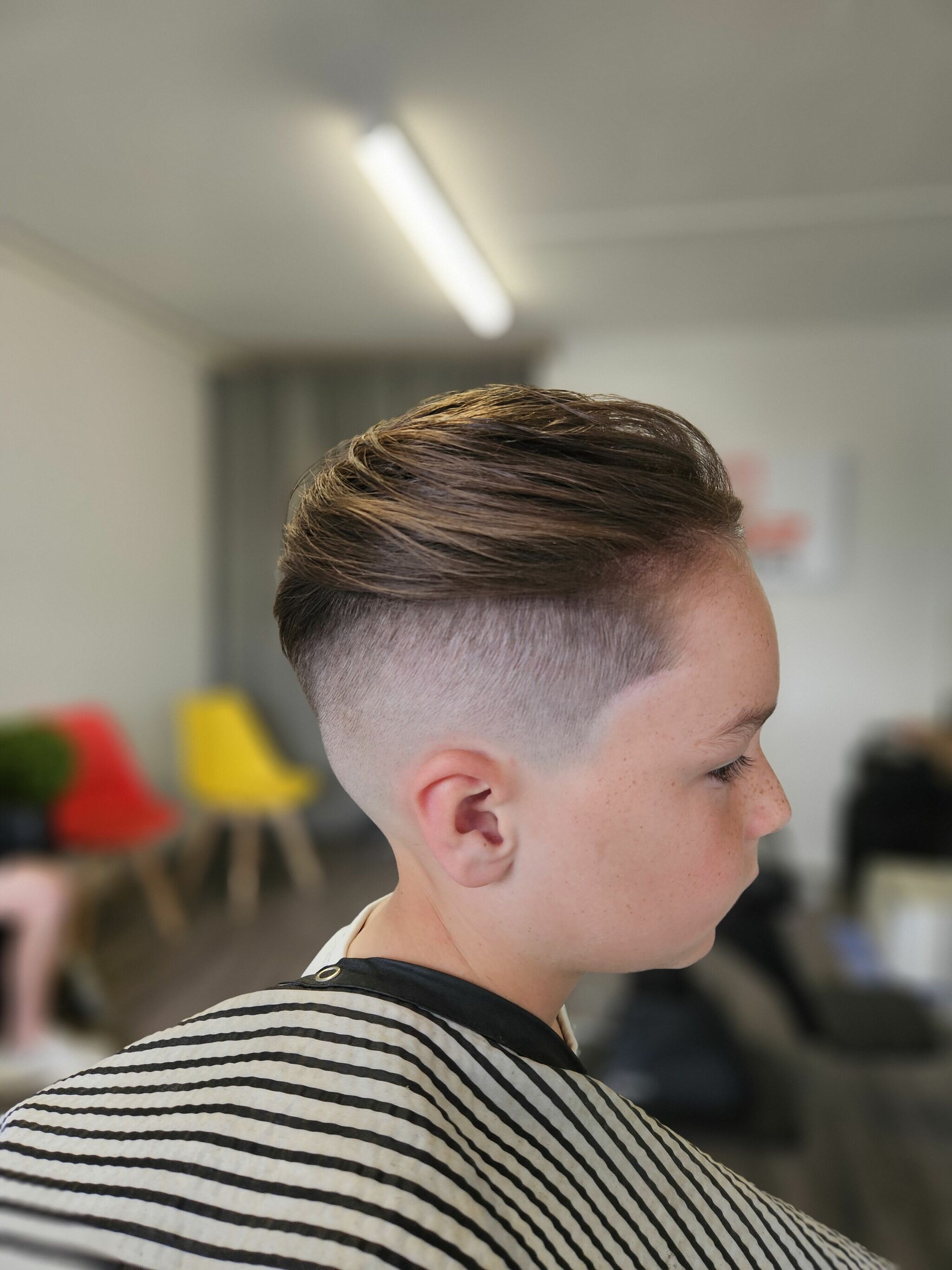 Young customer with a side part and fade